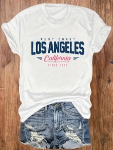 Flat lay of white cotton T-shirt with West Coast print and frayed denim shorts