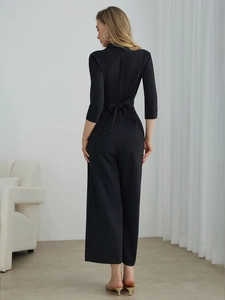 Elegant black V-neck jumpsuit for women with wide-leg cut and chic back bow tie detail