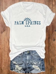 Minimalist white round neck T-shirt with vintage Palm Springs print and denim shorts outfit