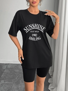 Women's black casual two-piece set featuring a printed graphic T-shirt and cycling shorts