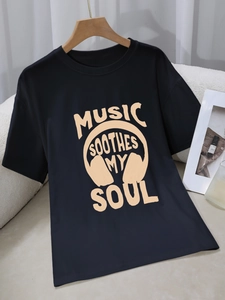 Black cotton round neck T-shirt featuring Music Soothes My Soul graphic print on a hanger