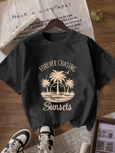 Women's black cotton t-shirt with retro beach sunset print and relaxed fit