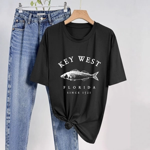 Detail of black cotton T-shirt featuring white fish print and stylish front hem knot