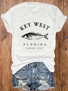 Women's white casual cotton t-shirt with fish print paired with blue ripped denim shorts