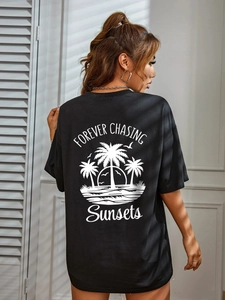 Women's black casual t-shirt with a white tropical sunset print on the back