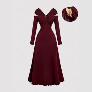 Detail of wine red V-neck dress featuring gold heart buckle and pleated A-line fabric texture