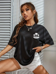 Detail of black cotton T-shirt featuring a white coconut tree print on the chest