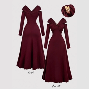 Detail of dark red V-neck dress featuring gold metal ornament and pleated texture