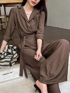 Elegant solid dark brown V-neck long sleeve wide-leg jumpsuit with waist tie detail