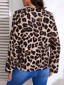 Detail view of the back of a women's leopard print long-sleeve top with brown and beige tones