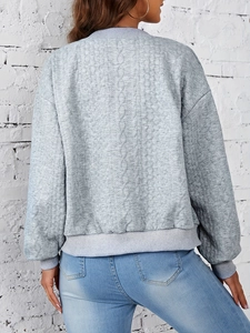 Back view of a grey quilted jacket with diamond patterns and ribbed knit cuffs