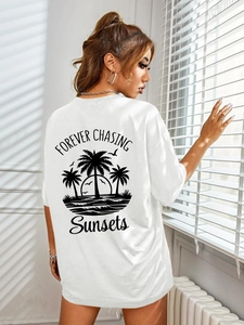 Detail of white oversized T-shirt with palm tree sunset graphic print on the back
