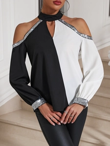 Detail of silver sequins on cold shoulder sleeve and black white contrast fabric