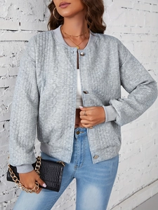 Detail of grey quilted varsity jacket with silver buttons and rib-knit cuffs on a model