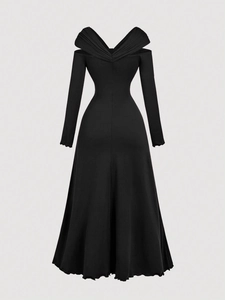 Detail of elegant black V-neck dress with pleated texture and ruffled hemline finish