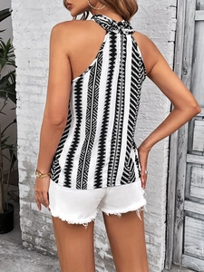 Women's halter neck striped top with geometric patterns and white denim shorts