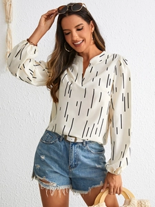 Detail of notch V-neck shirt with vertical stripes and elegant lantern sleeves