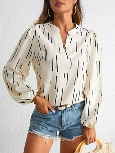 Detail of notch V-neck blouse with black vertical stripes and lantern sleeves