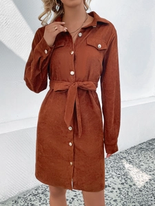 Women's brown corduroy shirt dress with long sleeves, lapel collar, and waist belt