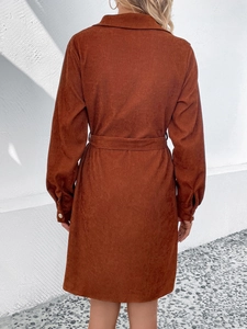 Back view of a caramel corduroy shirt dress with long sleeves and a matching waist belt