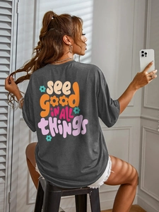 Women's dark grey oversized t-shirt with colorful vintage back print and white denim shorts