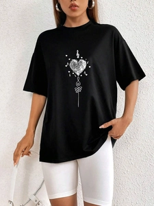 Close-up of black oversized t-shirt featuring a white fingerprint heart and music notes
