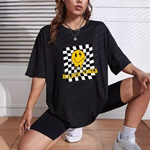 Women's black loose T-shirt and biker shorts set with melting smiley face and happy vibes print
