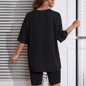 Back view of women black oversized t-shirt and cycling shorts set with checkerboard print