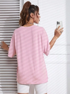 Back view of a casual pink drop-shoulder T-shirt with soft texture and loose fit
