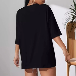 Back view of women's oversized black t-shirt with crew neck and loose cotton fit