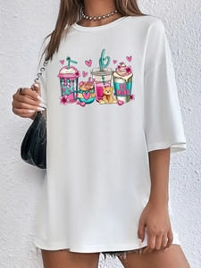 Close-up of a white oversized t-shirt featuring colorful cartoon beverage and heart prints
