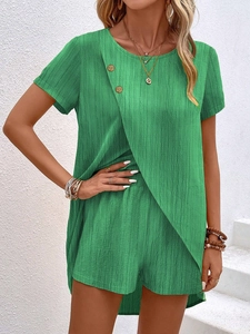 Detailed macro view of women's green linen set featuring textured fabric and wooden buttons