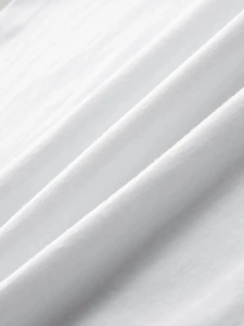 Detailed macro view showing breathable high-quality white cotton fabric texture of the T-shirt