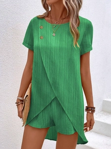 Detail of green two-piece set featuring crossover hem top and pleated texture fabric