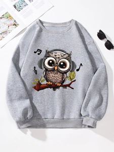 Flat lay of gray sweatshirt featuring a cartoon owl with headphones and musical notes