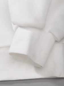 Macro shot of white ribbed knit cuffs and hem on a premium 220g cotton blend sweatshirt