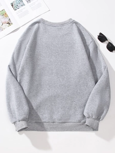 Detailed back view of grey crewneck sweatshirt with ribbed cuffs on white surface