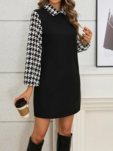 Close-up of elegant lantern sleeves with classic black and white houndstooth pattern