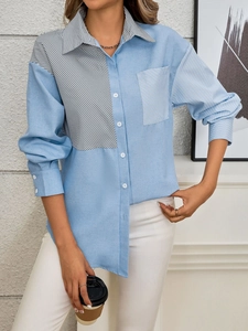 Detail of color block striped shirt showing asymmetric fabric patchwork and front pocket