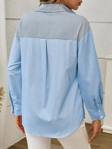 Detail view of the back pleat design on a striped patchwork casual shirt for women
