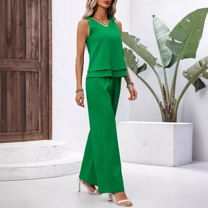 Chic emerald green two-piece set featuring a V-neck sleeveless top and high-waisted wide-leg pants