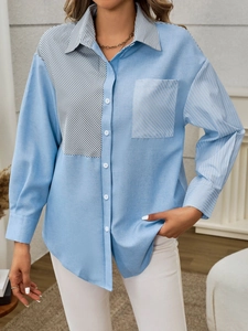 Detail of light blue striped patchwork shirt with button-down collar and chest pocket