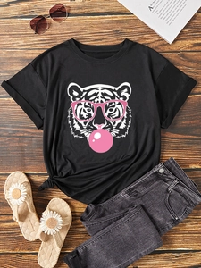Flat lay of black cotton t-shirt with artistic white tiger print and pink bubble detail
