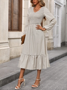 Detail view of smocked waist design on women's floral V-neck long sleeve dress