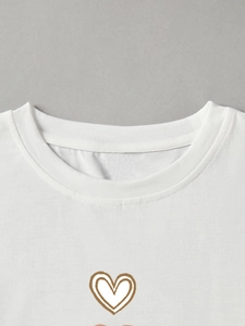 Detail of soft cotton white T-shirt featuring a brown heart print and round neckline