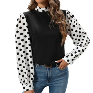 Elegant mock neck blouse with contrast polka dot sleeves and sleek black bodice design