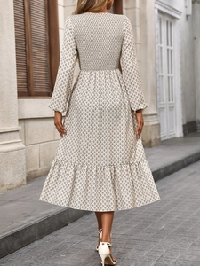 Detail view of smocked back and floral pattern on an elegant long sleeve autumn dress