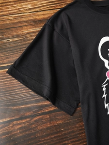 Detail shot of the double-stitched hem on a black cotton cartoon tiger graphic tee