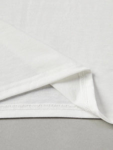 Detailed close-up of double-needle stitching and hem finish on a white cotton T-shirt