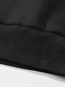 Close-up of black ribbed hem on a casual cotton sweatshirt with high-quality knit texture